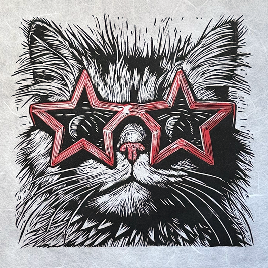 Linocut print of a cat wearing star shaped red sunglasses, very fine detail and the perfect gift for cat lovers.